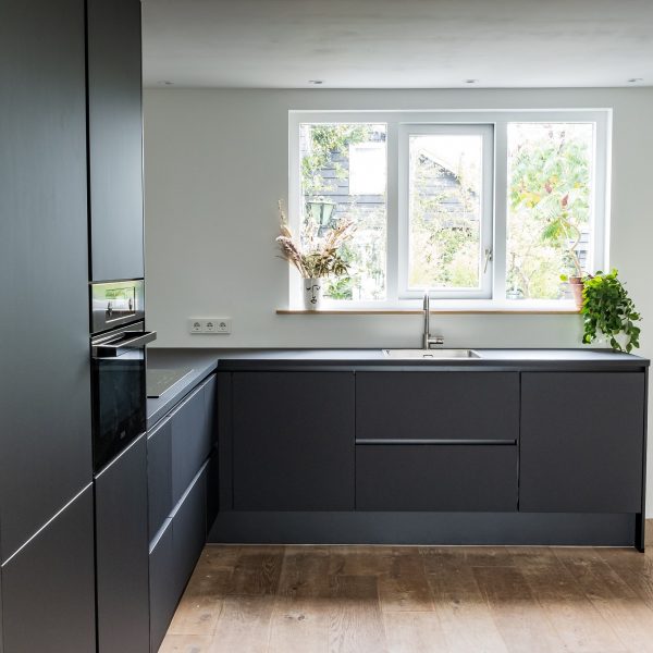 Clean, dark kitchen cabinets and counters and appliances